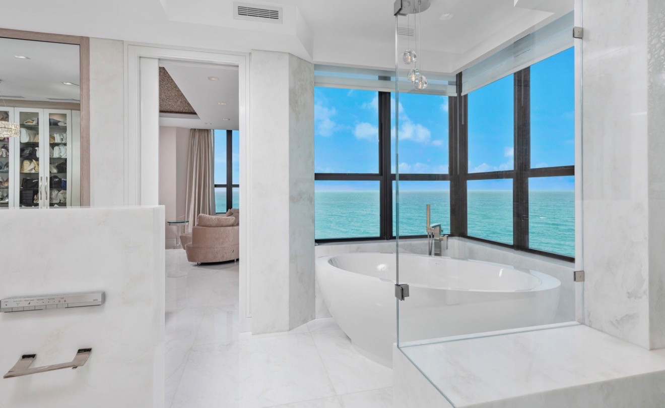 Oceanfront bathroom with a freestanding tub and wraparound water views