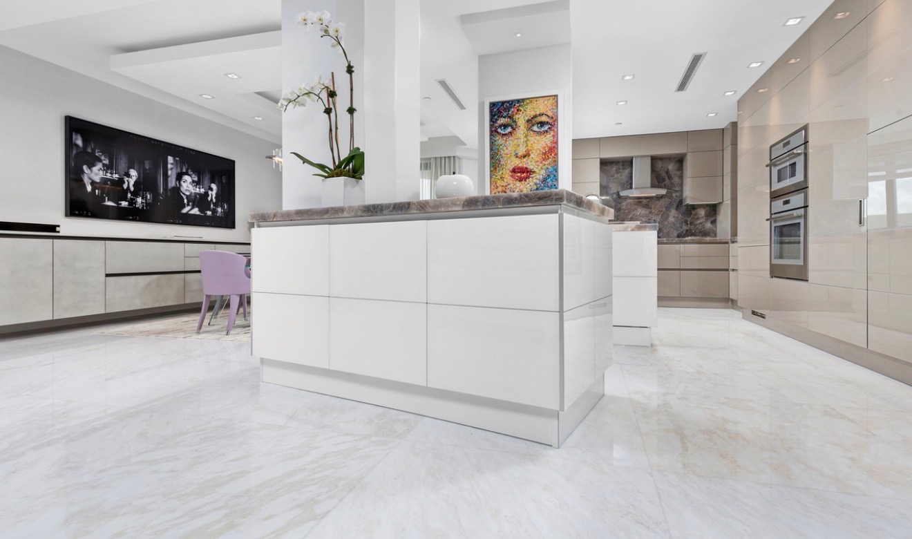 Open modern kitchen with a large white island and integrated cabinetry